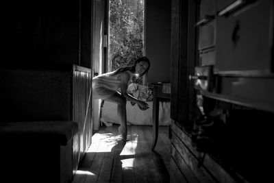 Young woman sitting in corridor