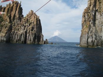 Panoramic view of sea and mountains against sky