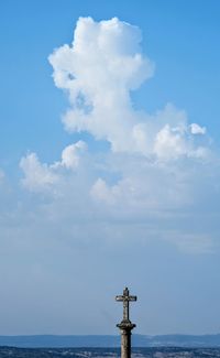 Wind turbines in sea against sky