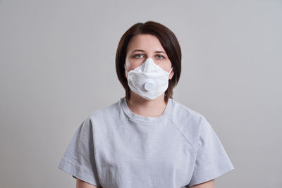 Portrait of woman standing against white background