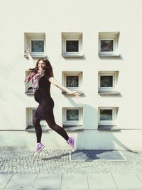 Full length of woman standing by railing