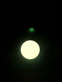 Low angle view of illuminated moon against sky at night