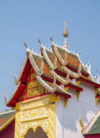 Carved floral pattern in the traditional thai style on the gable of the thai church