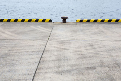 Bollard at harbor by sea