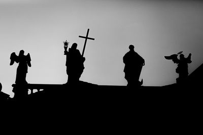 Low angle view of silhouette statue against clear sky