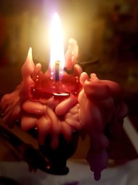 Close-up of lit candles on table