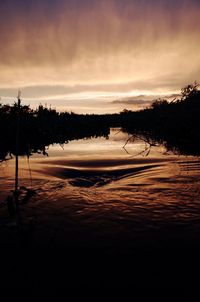 Scenic view of lake against sky at sunset