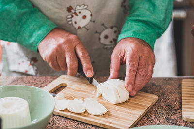 High angle view of person preparing food on cutting board