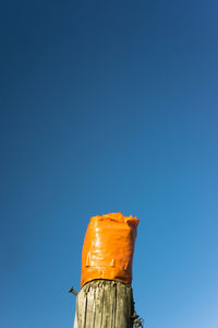 Low angle view of pole against blue sky