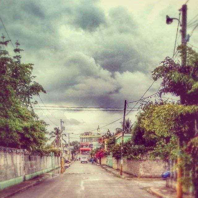 transportation, sky, cloud - sky, the way forward, road, cloudy, tree, electricity pylon, street, power line, car, built structure, building exterior, architecture, land vehicle, mode of transport, cloud, connection, diminishing perspective, weather