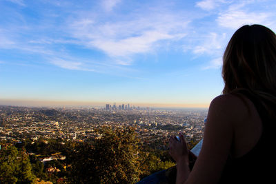 Rear view of woman with cityscape in background in la