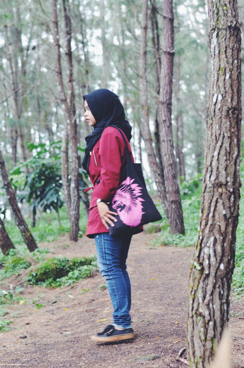 full length, tree, casual clothing, lifestyles, forest, leisure activity, tree trunk, rear view, standing, young adult, young women, person, walking, dress, nature, long hair, three quarter length