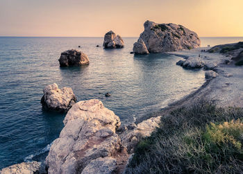 Scenic view of rocks in sea against sky