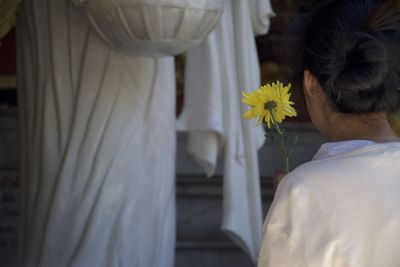 Rear view of couple holding bouquet