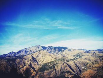 Scenic view of mountains against blue sky