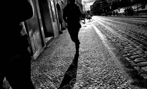 Rear view of man walking on railroad station platform