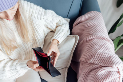 High angle view of woman sitting on bed