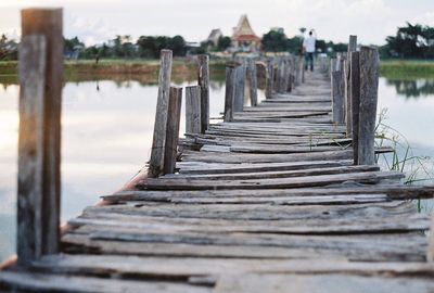 Surface level of wooden footbridge over river 