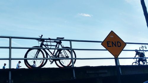 Low angle view of road sign against sky
