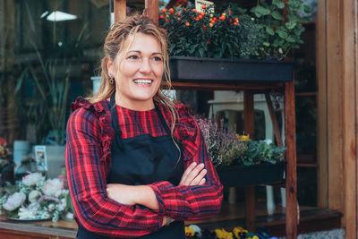 Portrait of smiling young woman standing outdoors