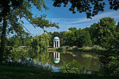 Gazebo by lake against sky