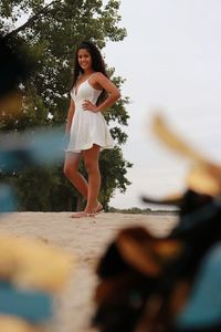 Full length of young woman standing on field