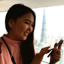 Close-up of young woman using smart phone