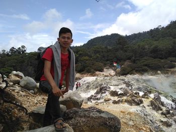 Portrait of smiling woman against sky