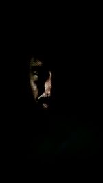 Woman looking away against black background