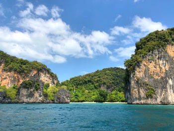 Scenic view of sea and mountains against sky