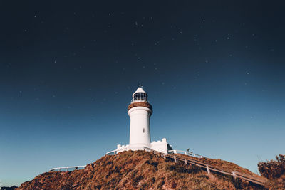 Low angle view of lighthouse against sky at night