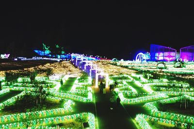 Illuminated city against clear sky at night