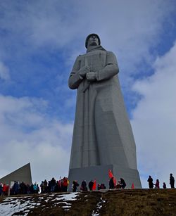 Low angle view of statues against sky