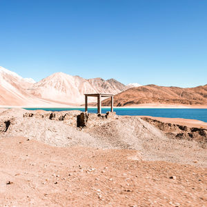 Scenic view of desert against clear blue sky