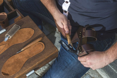 Close-up of shoemaker making sandal at workshop