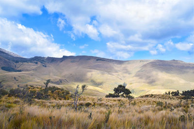 Scenic view of mountains against cloudy sky