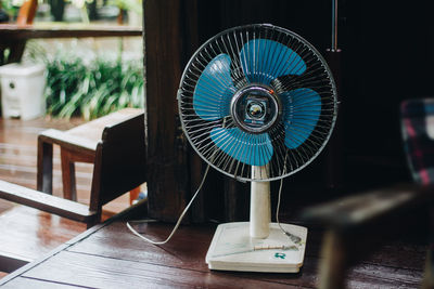 Close-up of electric fan on table at home