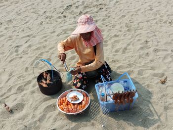 High angle view of woman sitting at beach