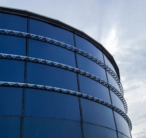 Low angle view of glass building against sky