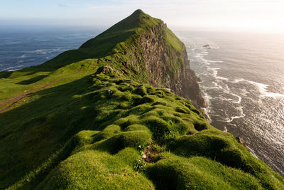 High angle view of sea and mountains against sky