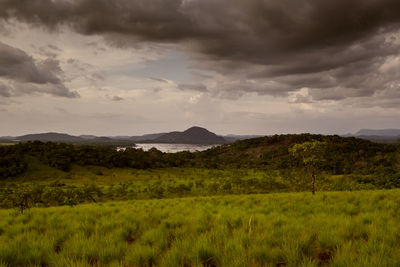 Scenic view of landscape against dramatic sky