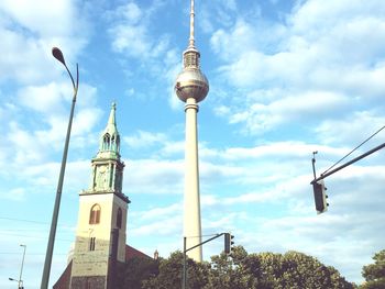 Low angle view of tower against cloudy sky