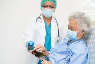 Female doctor examining patient in hospital