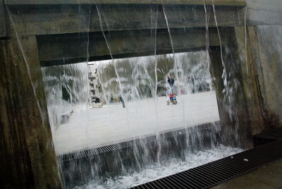 Man standing by dam on river