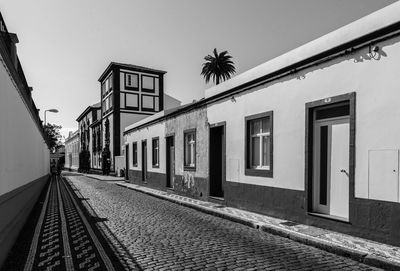 Railroad tracks by building against sky