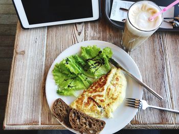 High angle view of breakfast served on wooden table