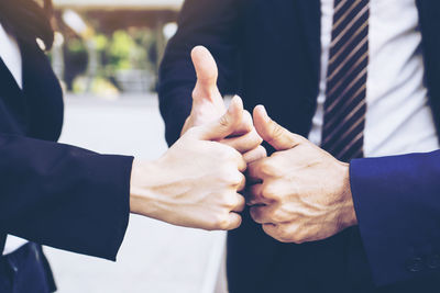 Midsection of man holding hands