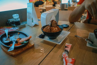 Midsection of person having food on table