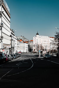 City street and buildings against sky