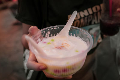 Midsection of person holding ice cream